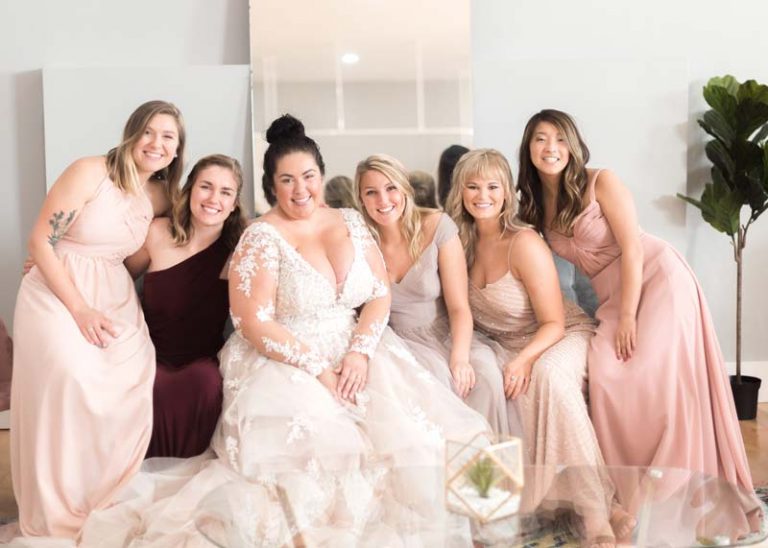 Image of a Twirl bride and her bridesmaids smiling and posing