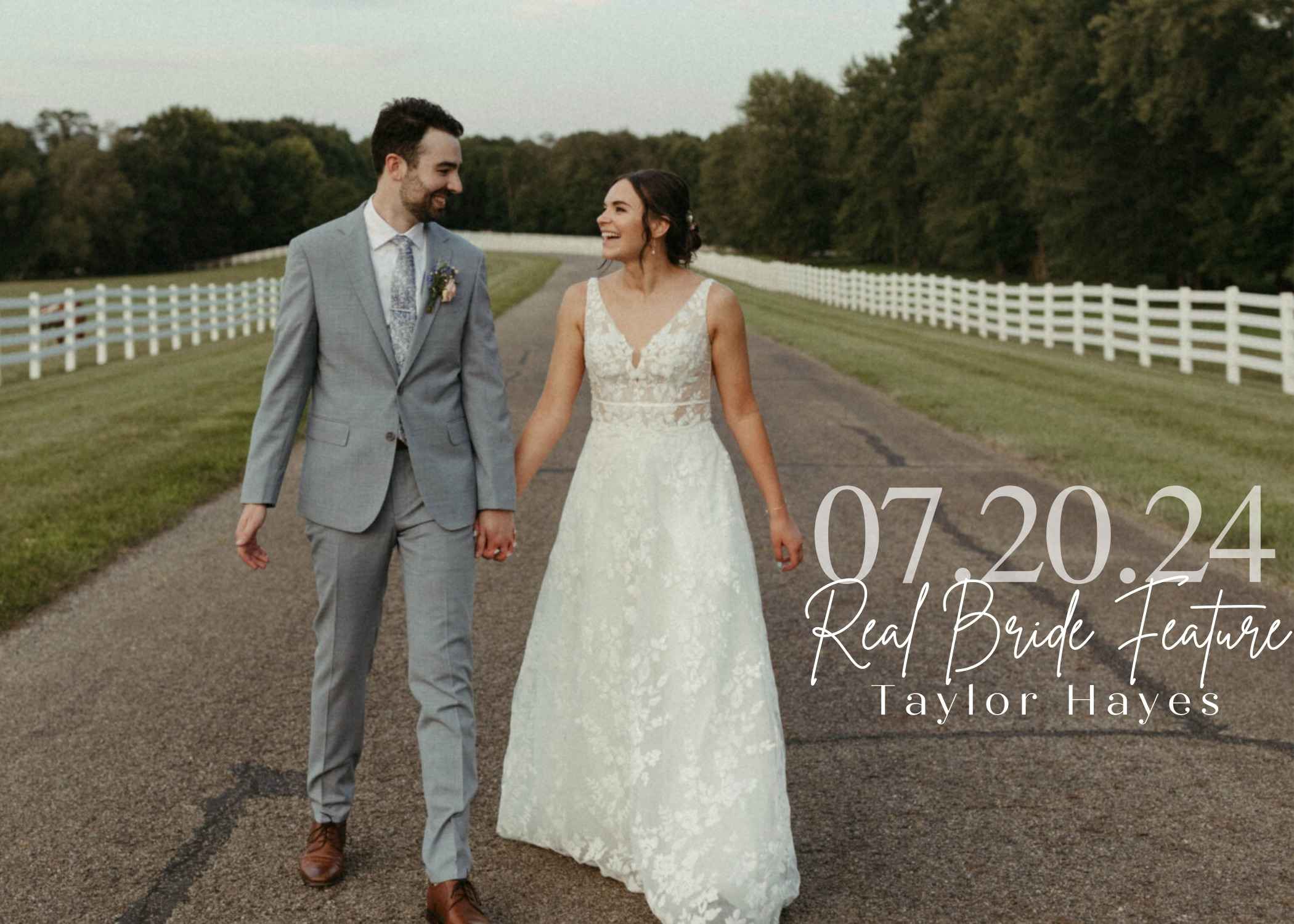 Bride Taylor Hayes walking hand-in-hand with her groom down a country road lined with white fences, wearing a lace V-neck wedding gown and smiling at him.