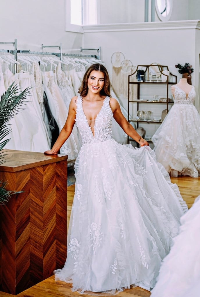 plunging neckline sleeveless wedding gown at twirl bride bridal shop in findlay ohio