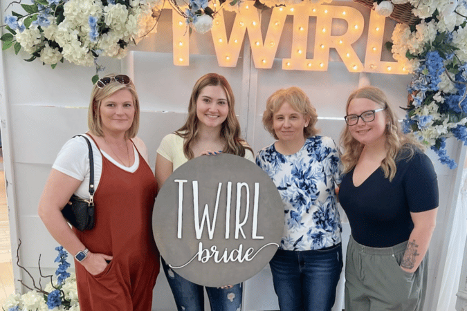 Bride posing with friends and family at Twirl Bride during a bridal shopping appointment.