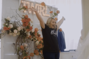 Bride celebrating during a wedding dress shopping appointment.