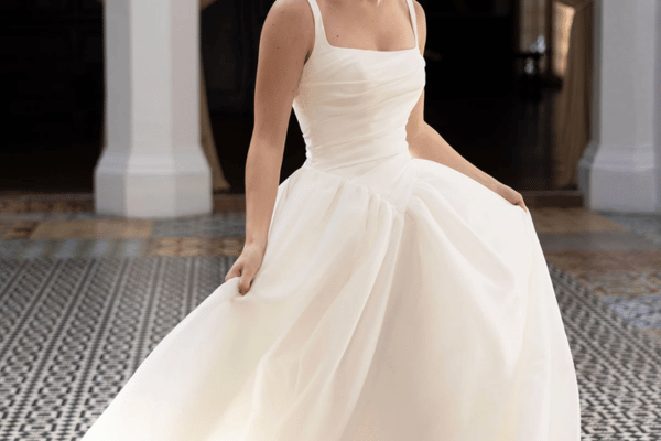Bride wearing an A-line wedding dress with a fitted bodice and full flowing skirt.