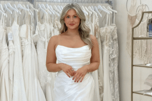 Bride wearing a wedding dress in a bridal boutique while exploring options and backup plans for a delayed wedding gown.