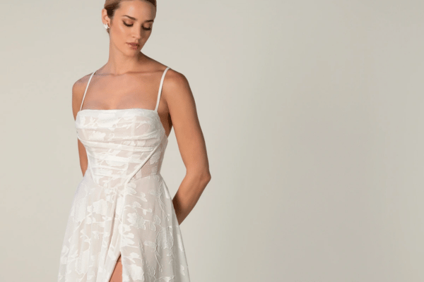 Bride wearing a floral A-line wedding dress with a square neckline and front slit