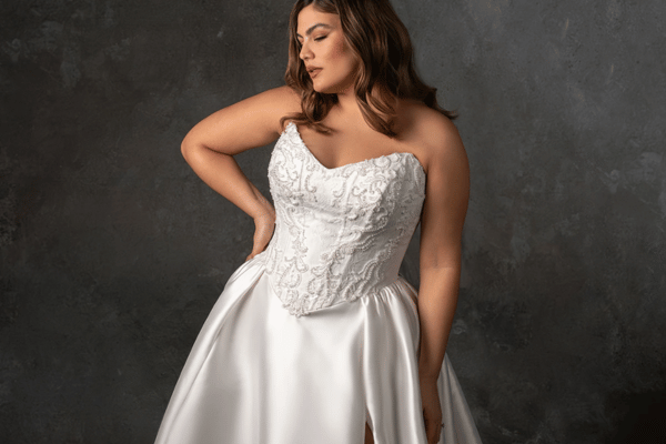 Bride wearing a strapless satin A-line wedding dress with a lace corset bodice